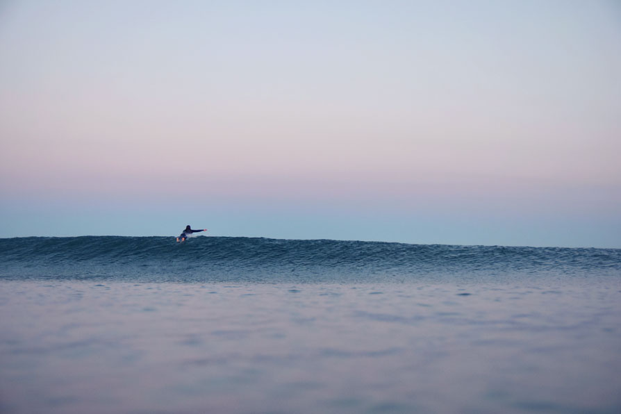 Paddling over a pretty little wave.